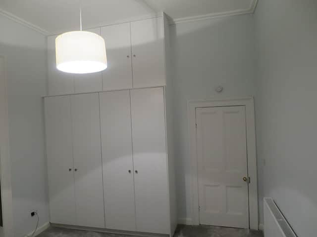 Wardrobe with storage on top for room with high ceiling